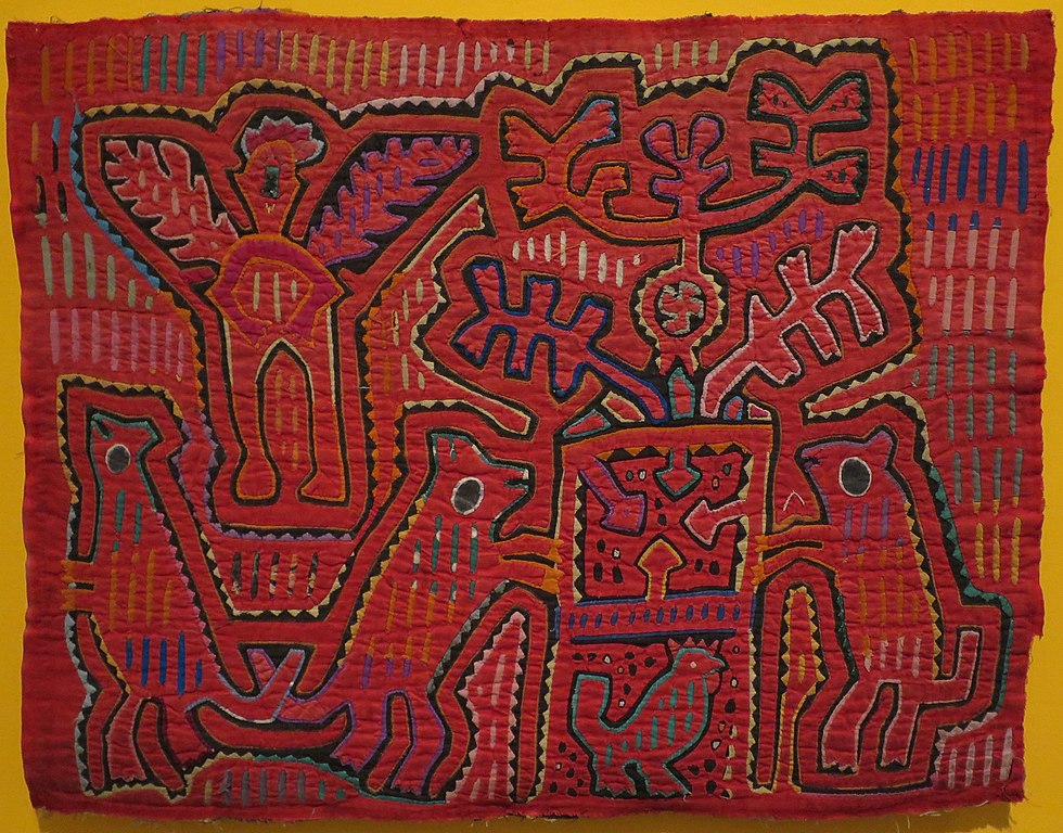 Tissage rouge pour blouse des Kunas du Panama représentant de façon abstraite quatre quadrupèdes et un oiseau autour d'un arbre.
