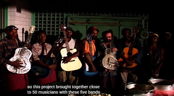 Le guitariste américain Bob Brozman et les groupes de cordes de Rabaul en Papouasie-Nouvelle-Guinée, tenant leurs instruments.